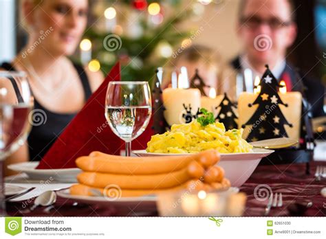 Stollen traditional christmas ftuitcake with dried fruit. German Christmas Dinner Sausages And Potato Salad Stock Photo - Image of candles, tradition ...