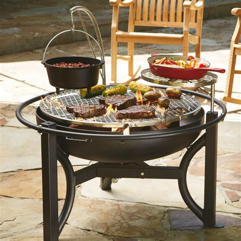 An Outdoor Bbq Grill With Various Foods On It And Two Chairs In The