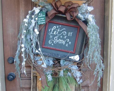 A Door With A Chalkboard Sign Hanging From Its Side And Wreath On The