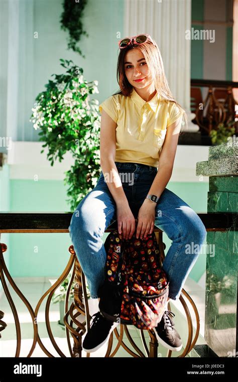 Young Teenage Girl Sitting On Stair Railings Wear On Yellow T Shirt
