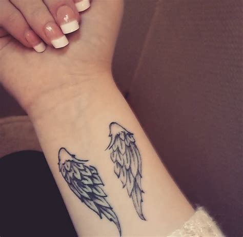 Small Angel Wings Tattoo On Wrist