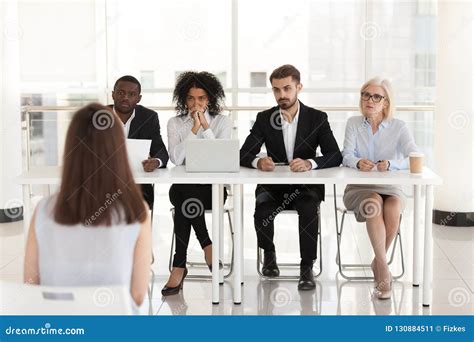Diverse Recruiters Listening To Female Applicant Talk At Intervi Stock