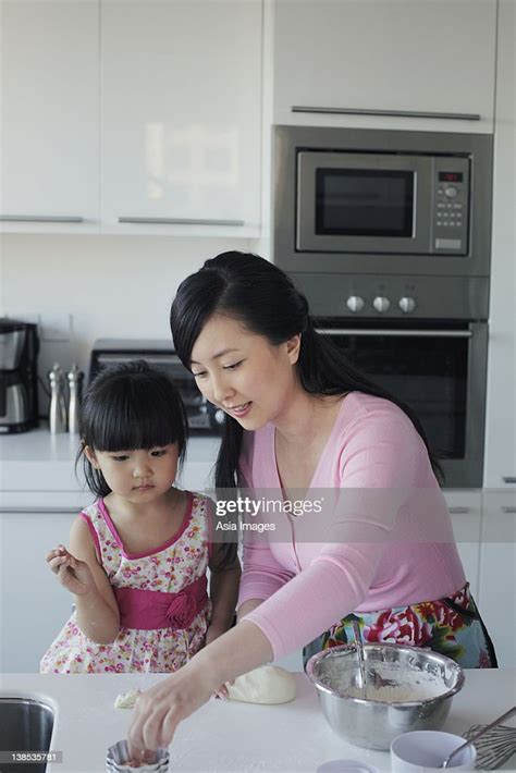 Mother Teaching Her Daughter How To Cook High Res Stock Photo Getty