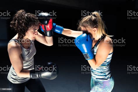 Two Professional Kick Boxers Sparring With Each Other Stock Photo