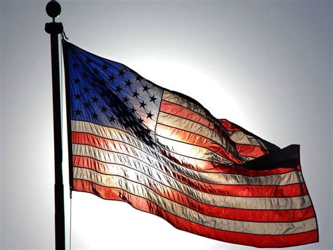 Download Waving American Flag In The Sun Wallpaper