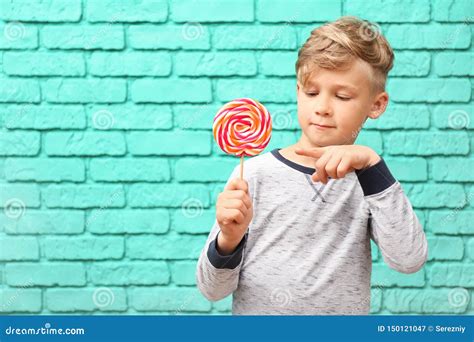 Cute Little Boy With Lollipop Near Color Brick Wall Stock Image Image