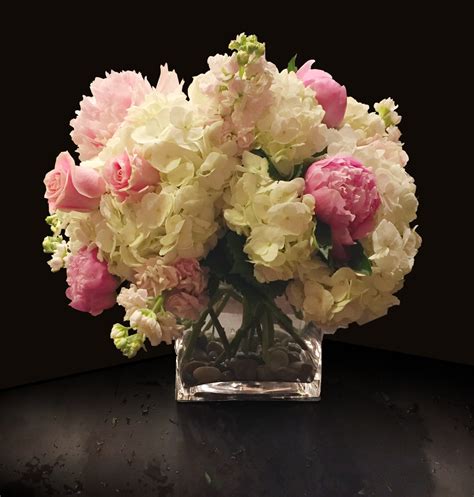 pink peonies hydrangeas stock roses in a large glass cube in washington dc shoots and
