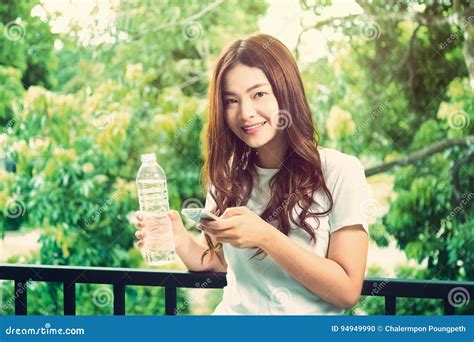 Happy Young Beautiful Healthy Asian Woman Holding Clear Bottle O Stock