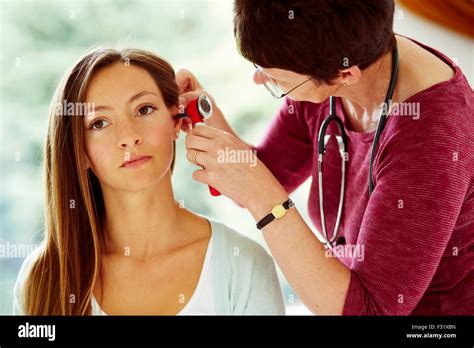Doctor Examining Patients Ears Stock Photo Alamy