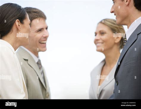 Four Business Associates Laughing Together Stock Photo Alamy