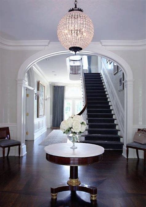 A glass entryway table in a sleek design always works well, especially if you have marble flooring, white walls, and a lot of light coming into the room. Round Foyer Table