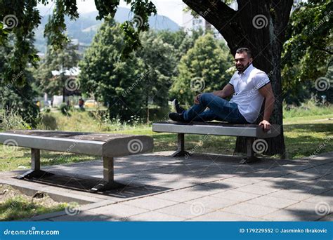 Handsome Young Man In Park Sitting On Bench Stock Photo Image Of