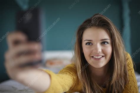 Teenage Girl In Bedroom Taking A Selfie Stock Image F0101056 Science Photo Library