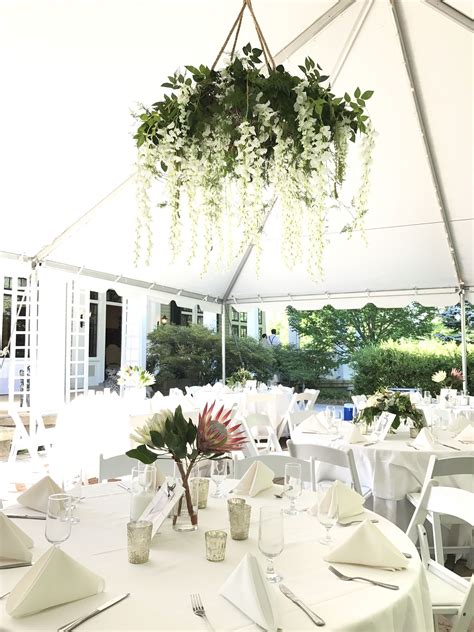 Floral Chandelier With Greenery And White Wisteria Wedding Flowers In