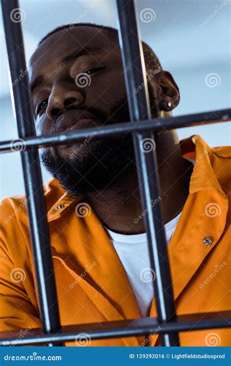 African American Criminal Looking At Camera Behind Stock Photo Image
