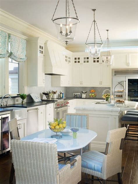 Kitchen cabinets are in a navy blue delivering a great contrast to the white kitchen island countertop. Creamy-White-Kitchen.-Coastal-Creamy-White-Kitchen-with ...