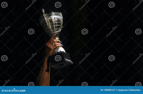 A Woman Holding Up A Gold Trophy Cup As A Winner Stock Image Image Of