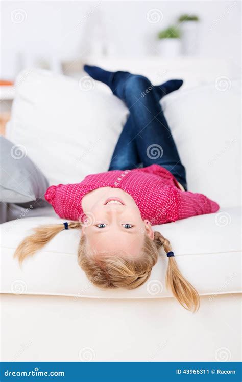 Smiling Girl Lying Upside Down On Sofa Stock Image Image Of Fitness