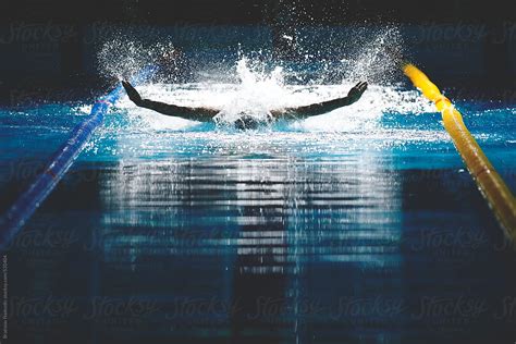 Male Swimmer Racing Performing Butterfly Stroke By Stocksy