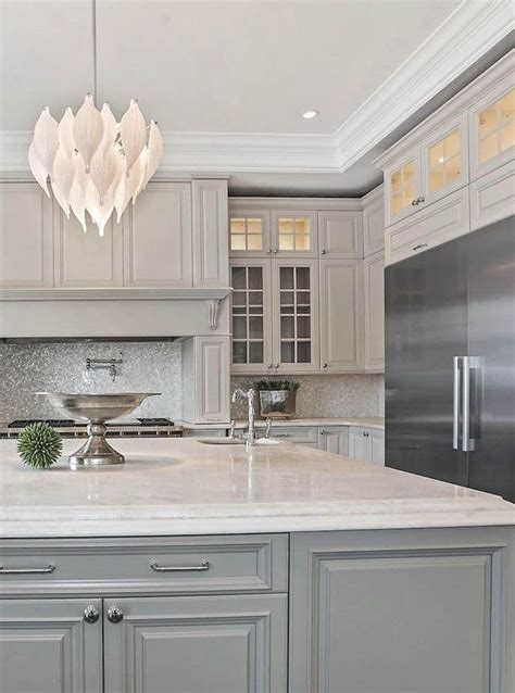 Wood, stainless kitchen cabinets range widely from $100 to $1,200 per linear foot. Cream gray cabinets with marble countertops & tile ...