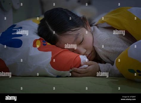 Asian Girl Sleeping In Room With Lights Off Stock Photo Alamy
