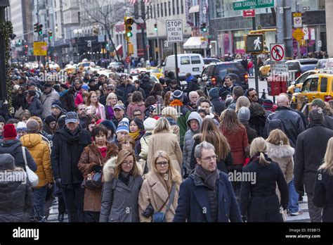 Crowds Of People Walk Along 5th Ave Near Rockefeller Center In