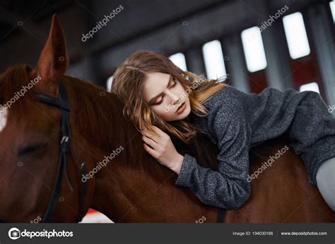 Young Woman Astride A Horse Stock Photo By ©photoagents 194030166