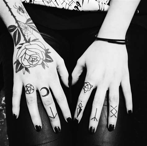 Two Hands With Different Tattoos On Them