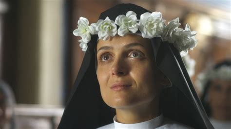 A Woman With Flowers In Her Hair Wearing A Nun S Headdress And Veil