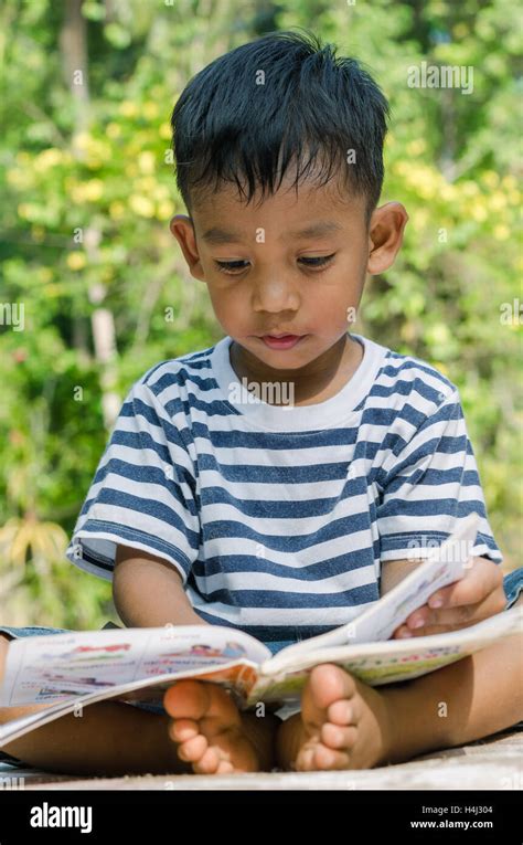 Asian Child Concentrate To Read A Book Stock Photo Alamy