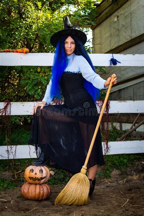 Cute Girl In A Witch Costume With Pumpkins And A Broom Stock Image Image Of Pumpkin