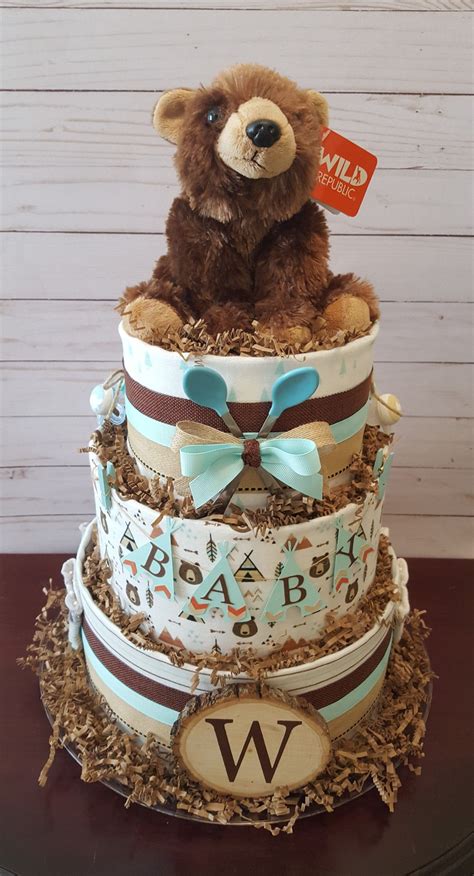 On the top tier, use tiny shoes or teddy bears. Woodland diaper cake, woodland baby shower centerpiece ...