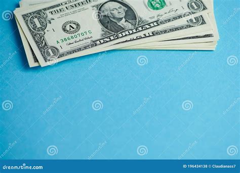 Stack Of One Dollar Bills On A Blue Background Stock Photo Image Of
