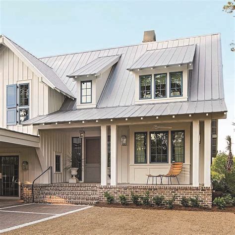 Classic white farmhouse with large porch and landscaped lawn. Metal Roofing - Homes Tre | Modern farmhouse exterior ...