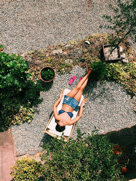 From Above Woman Tanning In A Home Garden By Stocksy Contributor