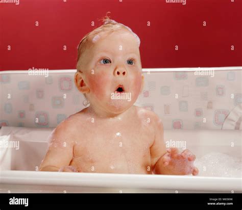 1960s Excited Surprised Baby In Bathtub Suds On Head And Funny Facial