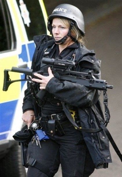 A Heavily Armed British Police Officer In Full Tactical Gear Shes