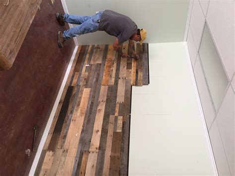 Recycled Pallet Wall Installation Sustainable Lumber Company