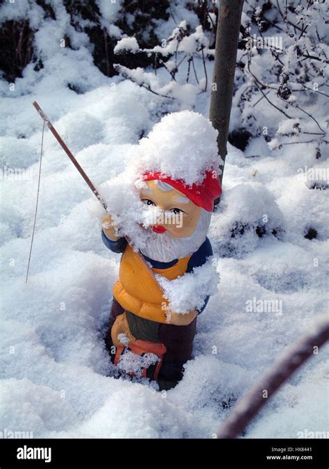Fishing Gnome Covered In Snow Stock Photo Alamy