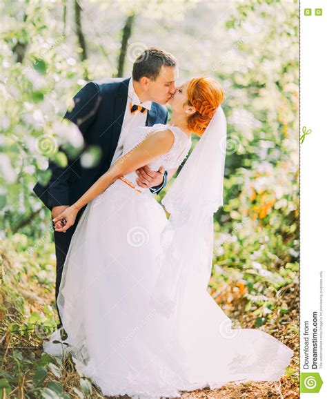 Happy Young Newly Married Couple Passionately Kissing In