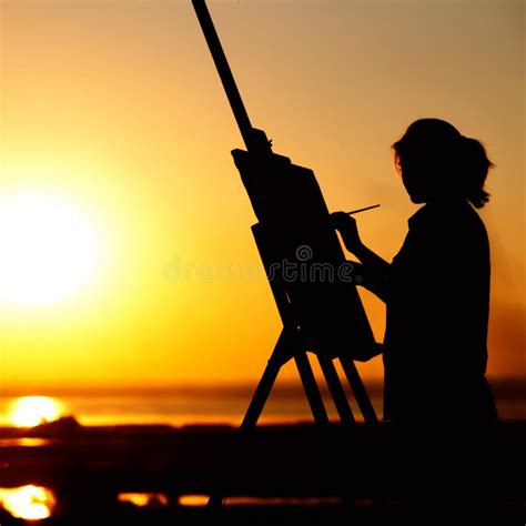 Silhouette Of A Young Woman Painting A Picture On An Easel On Nature