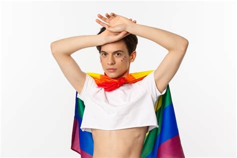 premium photo beautiful gay man with glitter on face wearing crop top and rainbow lgbt flag