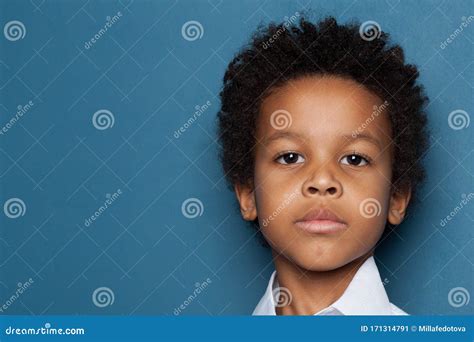 Serious Black Kid Boy Reading A Book On White Background Stock Photo