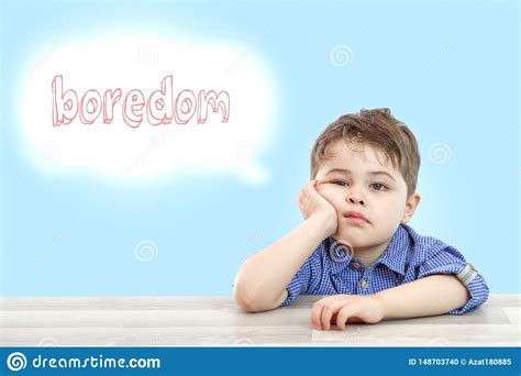Little Cute Boy Sits And Thinks Boredom On Bright Isolated Background