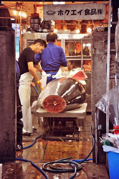 Tsukiji Fish Market At Tokio Japan A Fisherman Works The Giant Tuna