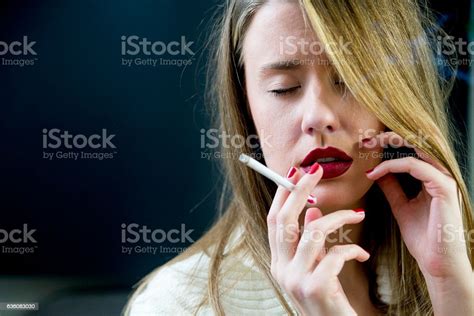 Sad Woman With Cigarette Exhaling Smoke Stock Photo Download Image