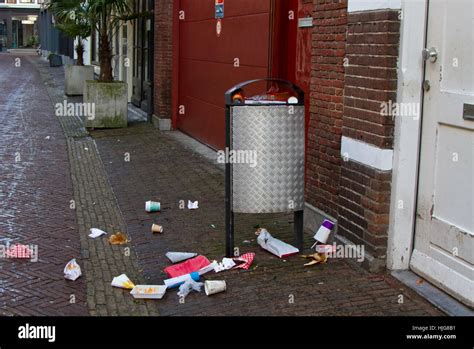 Overloaded trash bin in a street in the dutch city Haarlem ...