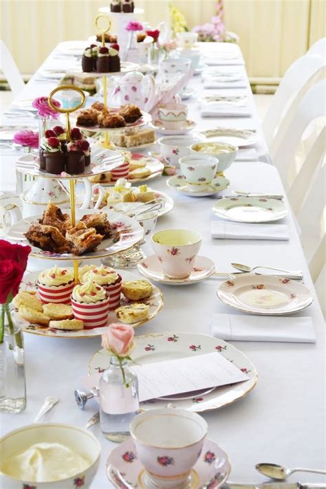 A Long Table Filled With Plates And Desserts On Top Of Eachother