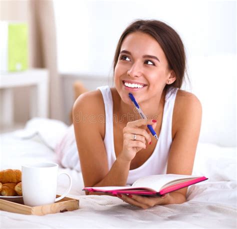 Young Beautiful Woman Lying In Bed Writing A Diary Stock Photo Image