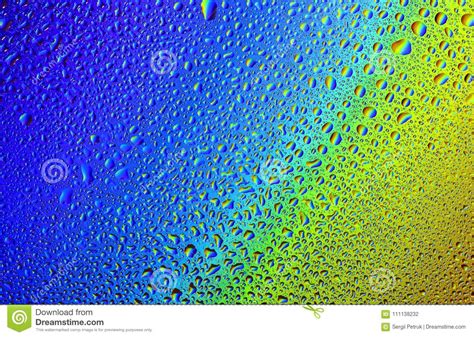 Drops Of Water On A Rainbow Background Stock Photo